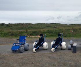 All four beach wheelchairs and platform system lined up on the beach